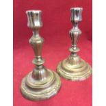 A pair of nineteenth century silver plated brass candlesticks, the fluted columns on circular