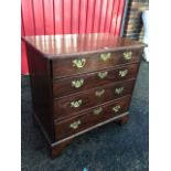 A George III mahogany chest of drawers, the moulded top with cut corners above four graduated