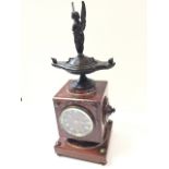 A nineteenth century rouge marble and bronze mantle clock, having French movement by Charpentier,