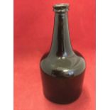 A large mallet shaped late eighteenth century wine bottle with tapering neck and moulded rim, the