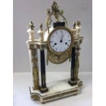 A regency marble mantle clock in the Egyptian taste having pillars with gilt metal anthemion and