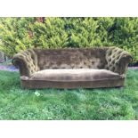A nineteenth century button upholstered chesterfield three-seater sofa, with padded back and arms