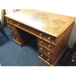 A Victorian oak kneehole desk, the rectangular moulded top with leather skiver above three frieze