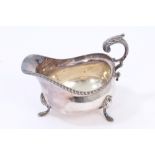 Contemporary silver sauce boat of conventional form, with gadrooned rim,