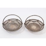 Pair Georgian silver swing-handled sweetmeat baskets of small proportions,