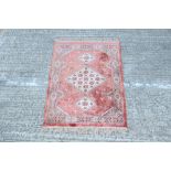 Small Eastern silk rug - with salmon-pink ground,