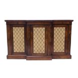 Regency rosewood breakfront credenza enclosed by three brass grille doors, on plinth base,