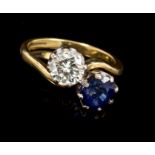 Diamond and sapphire two stone ring with a brilliant cut diamond estimated to weigh approximately 0.