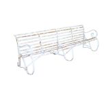 19th century wrought iron bench of large size, slatted construction on scrolled supports,