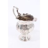 George III silver cream jug of baluster form, with fluted and raised floral decoration,
