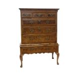 Early 18th century walnut crossbanded and feather-strung chest on associated stand,