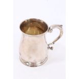 George II silver mug of baluster form, with scroll handle, on a circular foot,