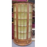 Glazed pine standing bow front display cabinet,