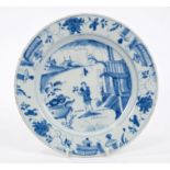18th century English blue and white Delft plate painted with a standing figure in a Chinese