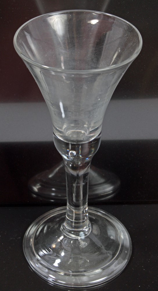 Georgian wine glass with trumpet-shaped bowl, air-bubble in base on plain stem,