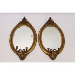Pair of 19th century oval gilt gesso girandole wall mirrors,