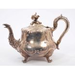 Victorian silver teapot of baluster form, with raised scroll decoration,