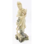 Old Chinese carved soapstone figure of Guanyin holding a flower,