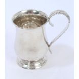 George V silver christening mug of baluster form, with leaf decorated scroll handle,
