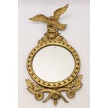 19th century gilt gesso wall mirror with circular later plate within lozenge carved frame with