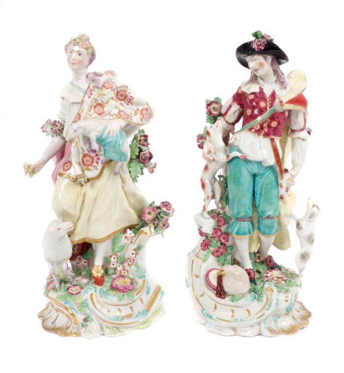 Pair 18th century Chelsea figures of a shepherd with pipes and dogs and shepherdess with sheep and