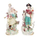 Pair 18th century Chelsea figures of a shepherd with pipes and dogs and shepherdess with sheep and