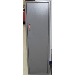 Modern grey metal gun cabinet with two sets of keys, to hold seven guns,