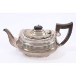 1920s silver teapot of compressed cauldron form, with bands of reeded decoration,