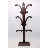 Victorian mahogany hall stand with central upright issuing scrolling arms, bulbous pegs,