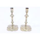 Pair early 18th century brass candlesticks with knopped stems and petal-shaped bases,