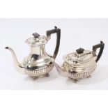 Edwardian silver teapot of fluted form with ebony handle and domed hinged cover, on four bun feet,