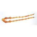Old amber bead necklace with a string of graduated amber and other beads - some possibly