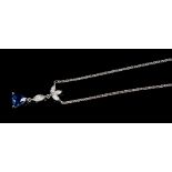 Diamond and sapphire pendant necklace with a triangular cut blue sapphire suspended from four