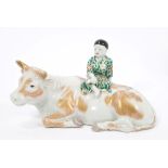 Late 19th century Japanese group of a boy seated on the back of a buffalo,