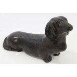 Bronze sculpture of a dachshund in alert pose,