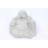 19th century Chinese blanc-de-chine figure of Pu-Tai Ho-Shang, seated, holding a rosary,