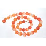Carnelian bead necklace with a string of graduated spherical beads, 16mm to 11.