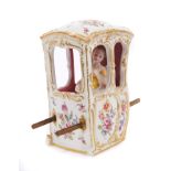 Late 19th century Dresden porcelain figure of a lady in a Sedan chair with polychrome painted