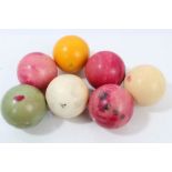 Seven antique carved and stained ivory snooker balls, each approximately 4.