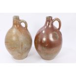 Two early 18th century Rhenish stoneware wine bottles with string necks,