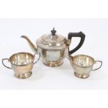 1930s three piece silver tea set - comprising teapot of cauldron form, with flower-head border,
