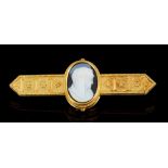 19th century gold Etruscan revival bar brooch with a central carved shell cameo depicting the