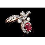 Unusual ruby and diamond cluster ring with an oval cluster centred with a mixed cut ruby weighing