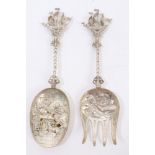 Pair 1920s Dutch silver serving spoon and fork with embossed tavern scene decoration,