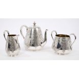 Three piece Victorian silver tea set - comprising teapot of carved form,