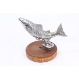 A vintage Desmo chrome plated car mascot in the form of a leaping salmon, on wooden base,