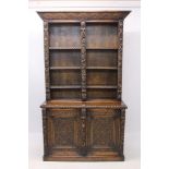 Late 19th century heavily carved oak bookcase with lunette cornice,