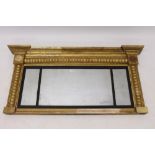George IV giltwood triple plate overmantel mirror with reeded ebonised slip and beaded surround,