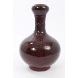 Chinese sang de boeuf bottle vase with onion neck and blue-speckled red glaze,