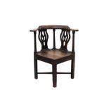 George III oak and elm corner chair with bowed arm rail and pierced splat,